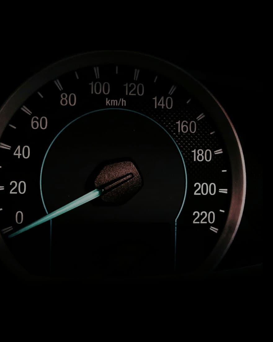 A glowing car speedometer in the dark