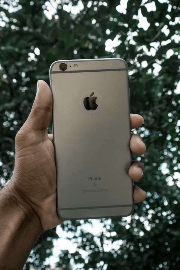 A hand holding up a smartphone