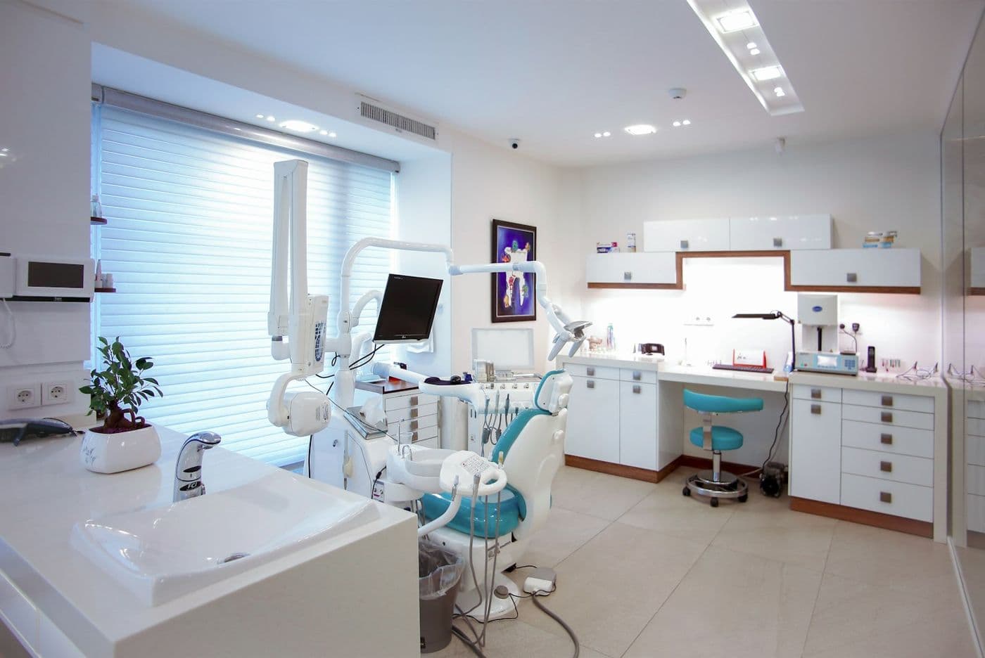 A bright, modern dental treatment room with a patient chair