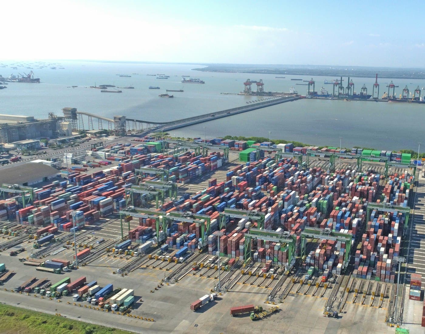 Aerial view of a busy shipping port stacked with containers